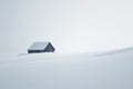 Snowy winter landscape with a wooden house in the middle of it