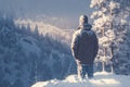 Serene solitude Man in winter forest, captivated by snowy scenery