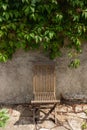 Serene Solitude: An Old Wooden Chair Amidst the Foliage