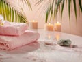 Serene spa environment with soft pink towels, candles and exotic flowers Royalty Free Stock Photo