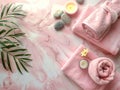 Serene spa environment with soft pink towels, candles and exotic flowers Royalty Free Stock Photo