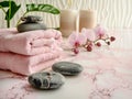 Serene spa environment with soft pink towels, candles and exotic flowers Royalty Free Stock Photo