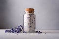 A serene spa setting with a glass jar of aromatic lavender salt sealed with a cork, surrounded by scattered lavender flowers, Royalty Free Stock Photo