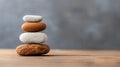 A serene stack of four smooth pebbles on a wooden surface, symbolizing harmony, balance, and tranquility in nature Royalty Free Stock Photo