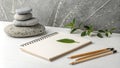 Serene Still Life Stacked Stones, Blank Notebook, Leaf, Pencils Royalty Free Stock Photo