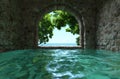 Serene stone arch overlooking tranquil pool and ocean Royalty Free Stock Photo