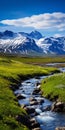A Serene Stream Flowing Through The Grassy Desert Towards An Icelandic Mountain