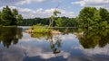 Serene summer lake landscape with reflections of sky and trees