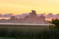 Foggy sunrise behind grain silos in Bad Ax, Michigan Royalty Free Stock Photo