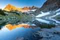 Serene sunrise at mountain lake with snowy peaks reflection Royalty Free Stock Photo