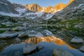 Serene sunrise at mountain lake with snowy peaks reflection Royalty Free Stock Photo