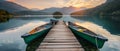 A serene sunrise reflects on a calm lake with two canoes docked on a wooden pier, inviting a peaceful morning paddle in Royalty Free Stock Photo
