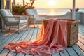 Serene sunset beach patio with basket and flowing pink fabric Royalty Free Stock Photo