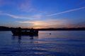 Serene Sunset Escapade: A Captivating Image of Two People Enjoying a Scenic Boat Journey Together