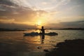 Serene sunset in the lake and boatman