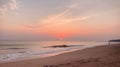 A serene sunset over a beach with soft pinks and oranges