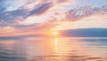 Serene sunset over calm ocean waters, with soft clouds reflecting warm hues Royalty Free Stock Photo