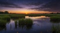 Golden Sunrise Reflecting on Calm Lake Waters with Green Grass and Cloudy Sky Royalty Free Stock Photo