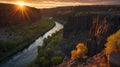 River Canyon at Golden Hour with Sunburst and Lush Vegetation Royalty Free Stock Photo
