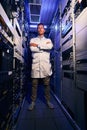 Serene IT technician standing alone in server room