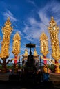 Serene Thai Monk Statue with Golden Sculptured Pillars
