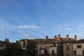 serene townscape with historical towers and a clear blue sky, accentuated by a solitary cloud