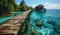 Serene tropical paradise with a wooden pier leading to overwater bungalows in a crystal-clear turquoise sea against a vibrant blue