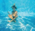 In serene underwater stillness, a boy finds tranquility in lotus position, embracing a moment of meditation in the Royalty Free Stock Photo