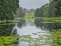 A serene view of Calke Abbey surrounded by lush gardens and historical architecture Royalty Free Stock Photo