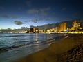 Serene Waikiki beach at night with a stunning city skyline in the backdrop with Hearts and Hope in the windows Royalty Free Stock Photo