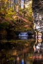 Serene waterfall reflects in the calm water and gorge Royalty Free Stock Photo