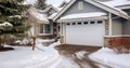 A Serene White Garage Door Entrance with a Roof and Yard Cloaked in Snow