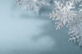 Serene Winter Elegance: Delicate Silver Snowflakes on Muted Blue for Holiday Layout Royalty Free Stock Photo