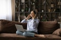 Woman listen music through headphones using streaming services on laptop Royalty Free Stock Photo