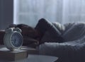 Woman sleeping in her bed and alarm clock Royalty Free Stock Photo
