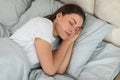 Serene woman sleeping peacefully in cozy bed Royalty Free Stock Photo