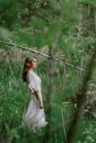 A Serene Woman in a White Dress by a Tranquil Body of Water Royalty Free Stock Photo