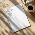 A Serene Workspace Aesthetic Featuring a Blank Page, Coffee Cup, and Natural Light on a Wooden Table Surface Royalty Free Stock Photo