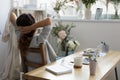 Serene young businesswoman relaxing in modern stylish creative workplace.