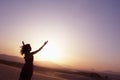 Serene young woman with arms outstretched doing yoga in the desert in China, Silhouette Royalty Free Stock Photo