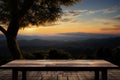 Serenity in a frame wooden table against sunset, sky, tree, mountains