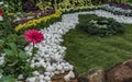 Serenity: Home Garden - White Pebbles, Lawn and Red Daisy flower Royalty Free Stock Photo