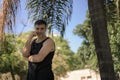 Serenity in Presence: Medium Shot Portrait of a Man Outdoors Under Palm Trees