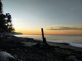 the serenity of the rocky beach in the afternoon with the orange light of the sunset