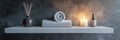 Serenity on a shelf, elegant arrangement of spa essentials featuring rolled towels, candle, and diffuser set against a Royalty Free Stock Photo