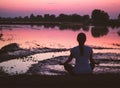 Serenity and yoga practicing, meditating at sunset background