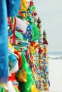 Serge. Sacred poles with colored ribbons in island Olkhon. Burkhan, Lake Baikal