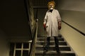 Serial murderer in creepy style of doctor clown on location of former hospital