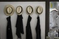 A series of Apron and sombrero mexican hat at the front door entrance of a small restaurant in Lisbon. Business concept and