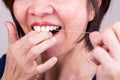 Series of Asian woman flossing teeth with oral floss